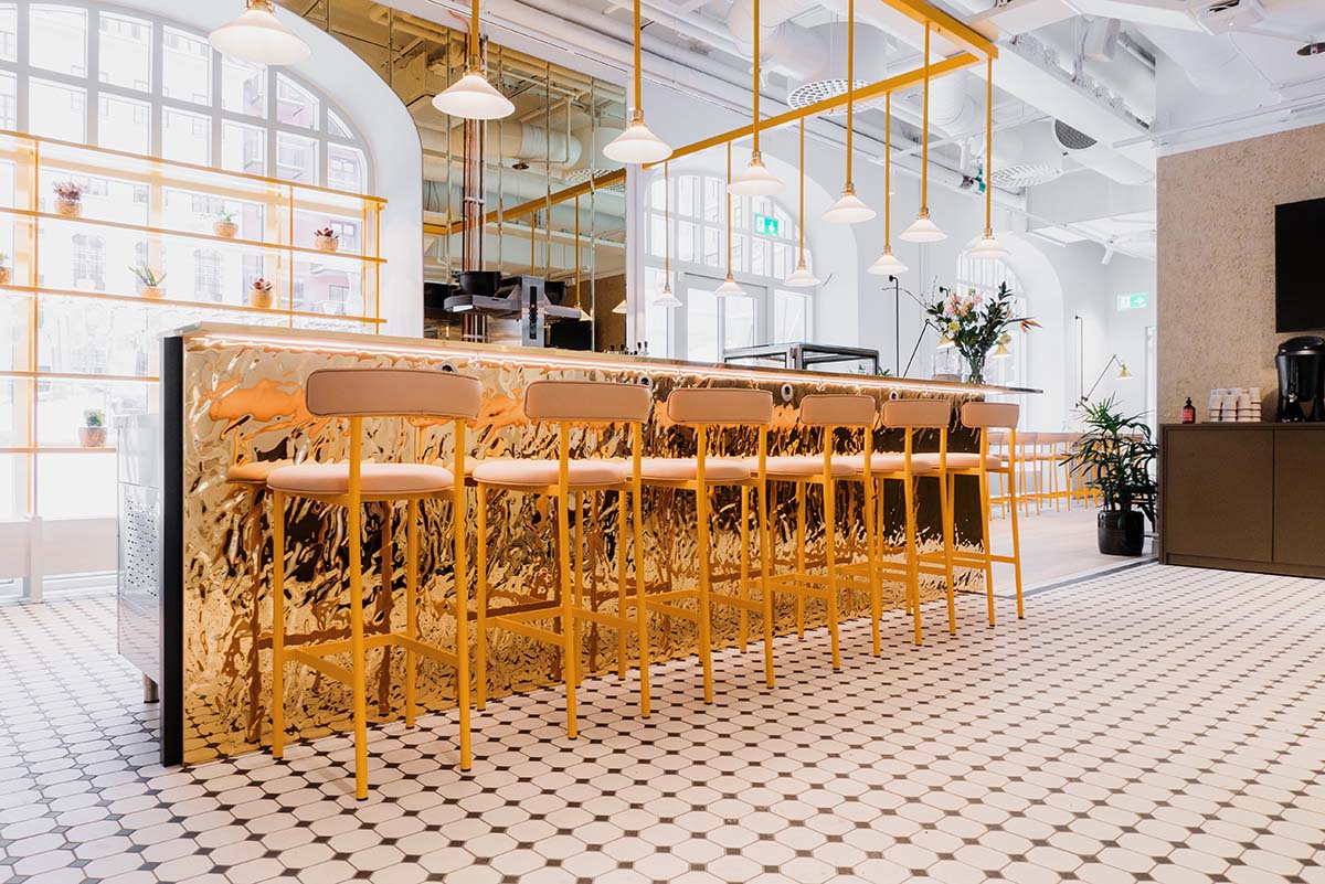A bar with golden chairs